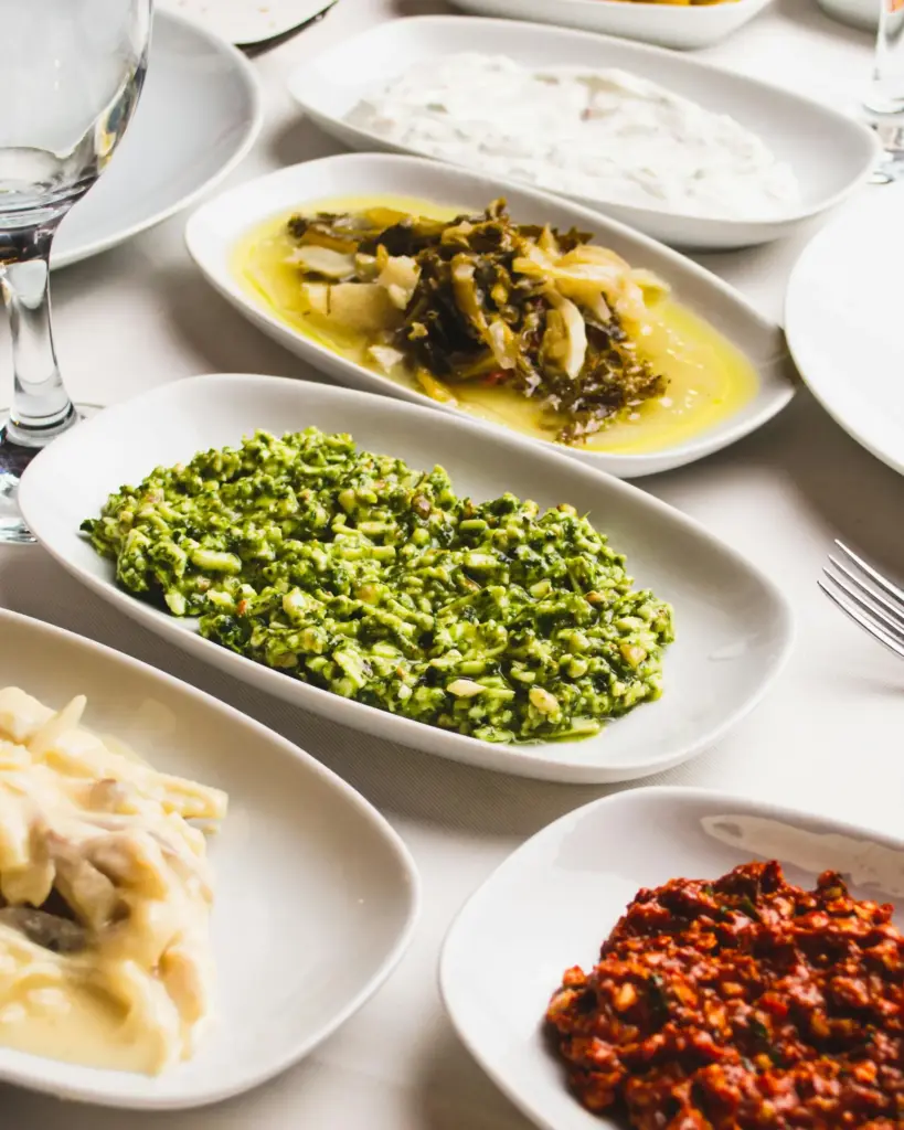 Zeytinyağlılar, yoğurtlu mezeler ve deniz mahsulleriyle dolu meze tabağı.
