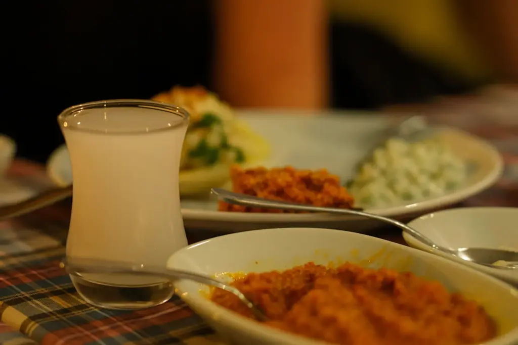 Rakılı sofrada meze çeşitleri ve çay bardağında servis edilen rakı.