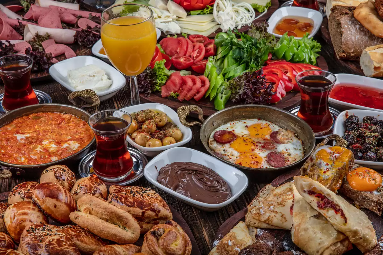 Antakya'yı ziyaret etmenin en lezzetli nedenlerinden biri olan sofrada boş yer bırakmayan bu yöresel kahvaltıda sucuklu yumurta, menemen, çeşitli peynirler, zeytinler, taze sebzeler ve hamur işleri iştah açıcı bir şekilde sergileniyor.