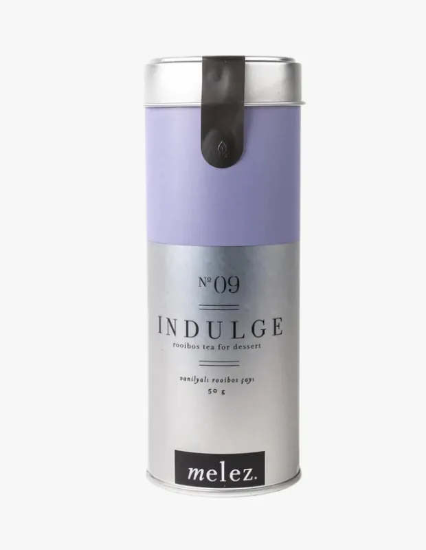 Lila ve metalik gümüş renkli şık silindirik kutuda vanilyalı rooibos çayı; Melez Tea No:09 INDULGE tatlı sonrası içim için.