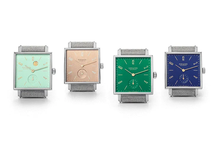 Nomos Glashütte Tetra serisinden dört farklı renk kadranlı kare saat modeli – yeşil, şampanya, zümrüt ve lacivert seçenekler.