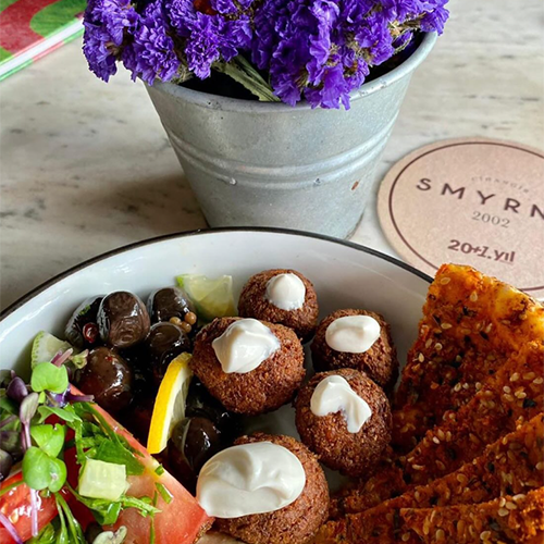 Cafe Smyrna Cihangir’in antikalarla dekore edilmiş yüksek tavanlı iç mekânı - Cihangir mekanları rehberi.