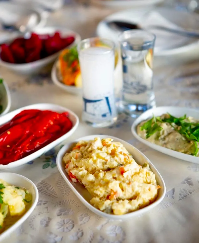 Madam Despina’nın Meyhanesi, Şişli'de mezeler, kırmızı biber ve patates salatası ile rakı sofrası sunumu
