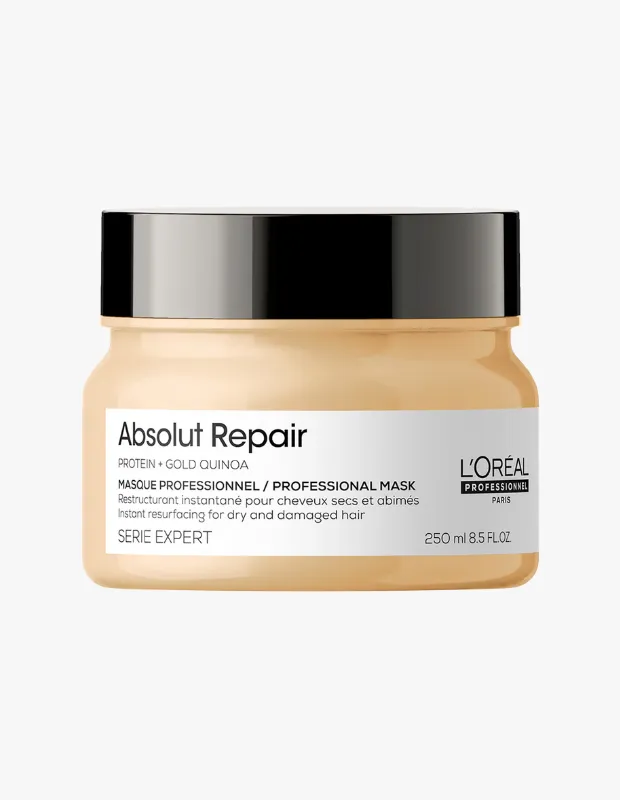 Beyaz bir arka plan üzerinde duran, Absolut Repair yazılı, L'Oréal Professionnel markasına ait, protein ve altın kinoa içeren, kuru ve yıpranmış saçlar için anında yeniden yapılandırma sağlayan 250 ml hacimli krem renkli bir saç maskesi kavanozu.