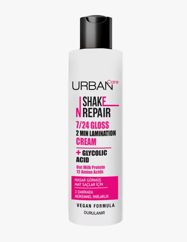 Beyaz şişeli, siyah kapaklı Urban Care Shake N Repair 7/24 Gloss 2 Min Lamination Cream, hasar görmüş mat saçlara 2 dakikada mükemmel parlaklık kazandırmak için glikolik asit ve yulaf sütü proteini içeren vegan bir formül sunar.