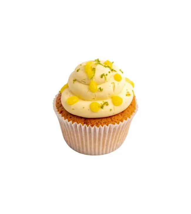 Üzeri limon kreması ve lime rendesiyle süslenmiş, beyaz kâğıtta sunulan vanilyalı cupcake.