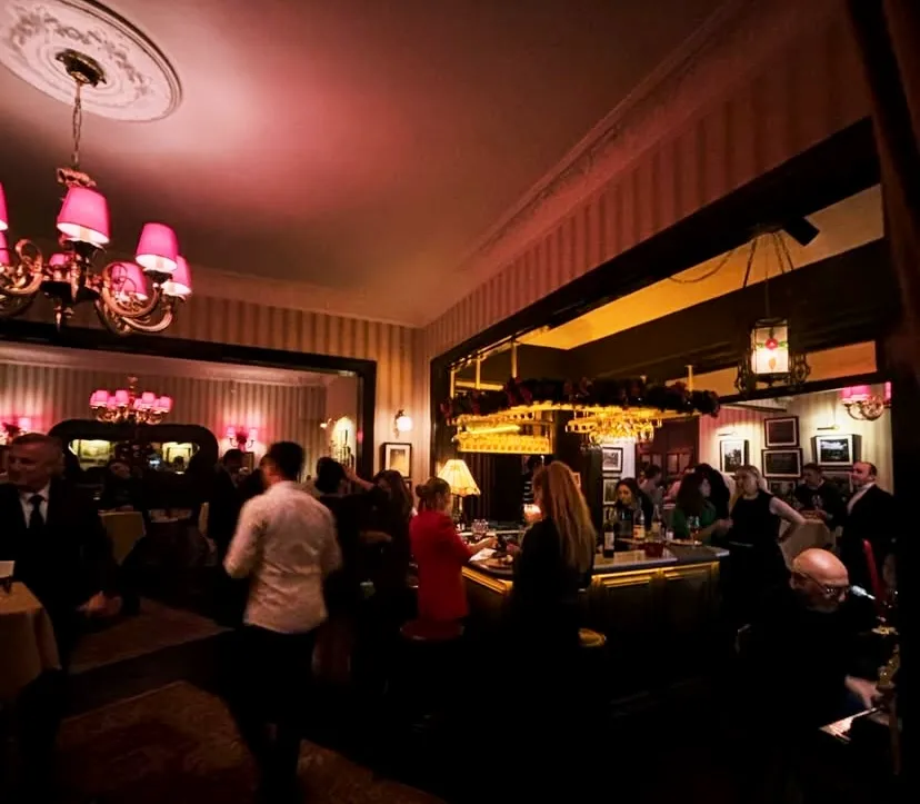 Jash Saloon loş ışıklı bar atmosferi, kalabalık akşam buluşması
