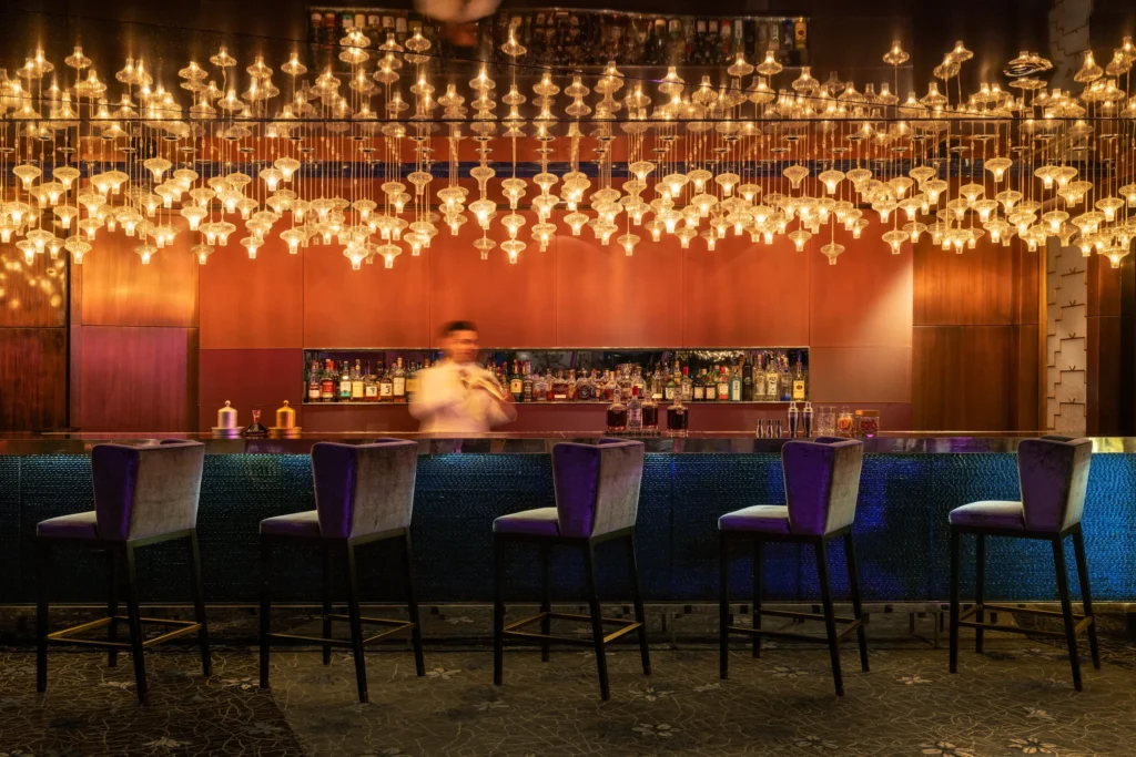 Raffles İstanbul’un ikonik Long Bar alanında canlı müzik sahnesi ve masa düzeni.