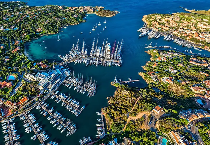 Marina di Porto Cervo’da lüks yatların demirlediği liman ve Costa Smeralda’nın turkuaz denizi