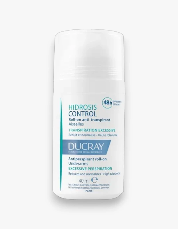Aşırı terlemeye karşı 48 saat etkili olduğu belirtilen, 40 ml hacimli, beyaz renkli ve turkuaz detaylı Ducray Hidrosis Control roll-on antiperspirant ürün, açık renk bir zeminde dikey olarak konumlanmış.