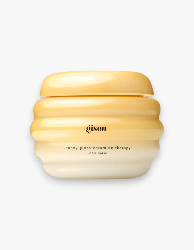 Bal peteği şeklindeki, üst kısımları bal rengi sarıdan dibe doğru kremsi beyaza doğru degrade olan Gisou Honey Gloss Ceramide Therapy saç maskesi, parlak ve sağlıklı saçlar için özel olarak formüle edilmiş bir bakım ürünüdür.