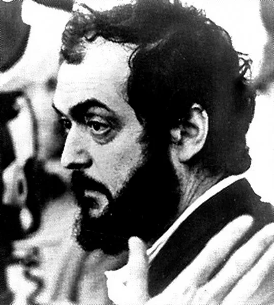 Siyah beyaz ve hafif grenli bir fotoğraf karesinde, efsanevi yönetmen Stanley Kubrick'in belirgin gür sakalı, dağınık saçları ve düşünceli profili, onun sinema hayatına dair derin bir bakış açısı sunuyor.