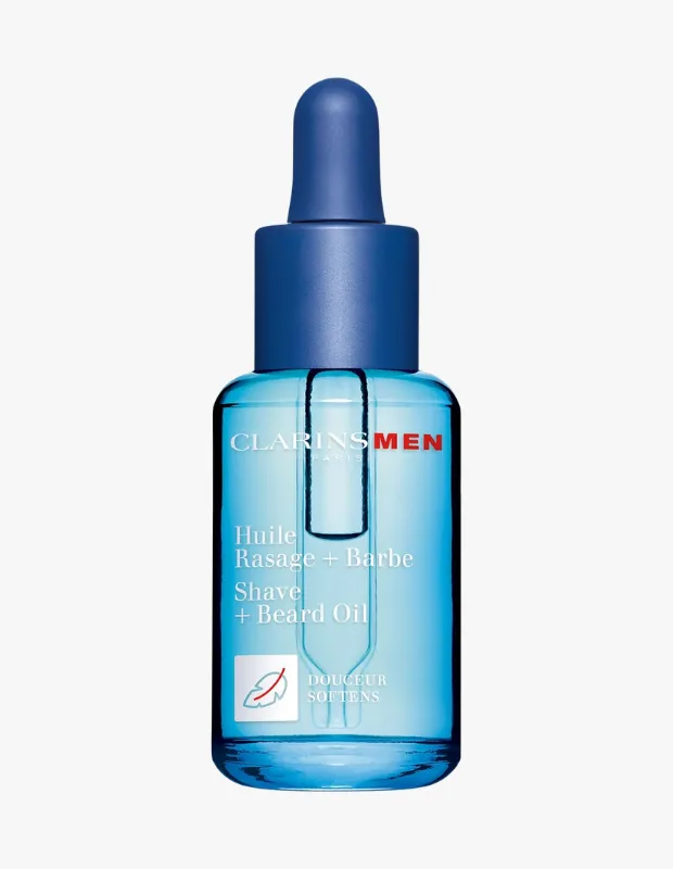 Beyaz bir zemin üzerinde duran, ClarinsMen markasına ait mavi damlalıklı kapaklı şeffaf şişede, üzerinde Huile Rasage + Barbe ve Shave + Beard Oil yazıları bulunan, sakal ve tıraş öncesi bakım için formüle edilmiş bir tıraş yağı görülmektedir.