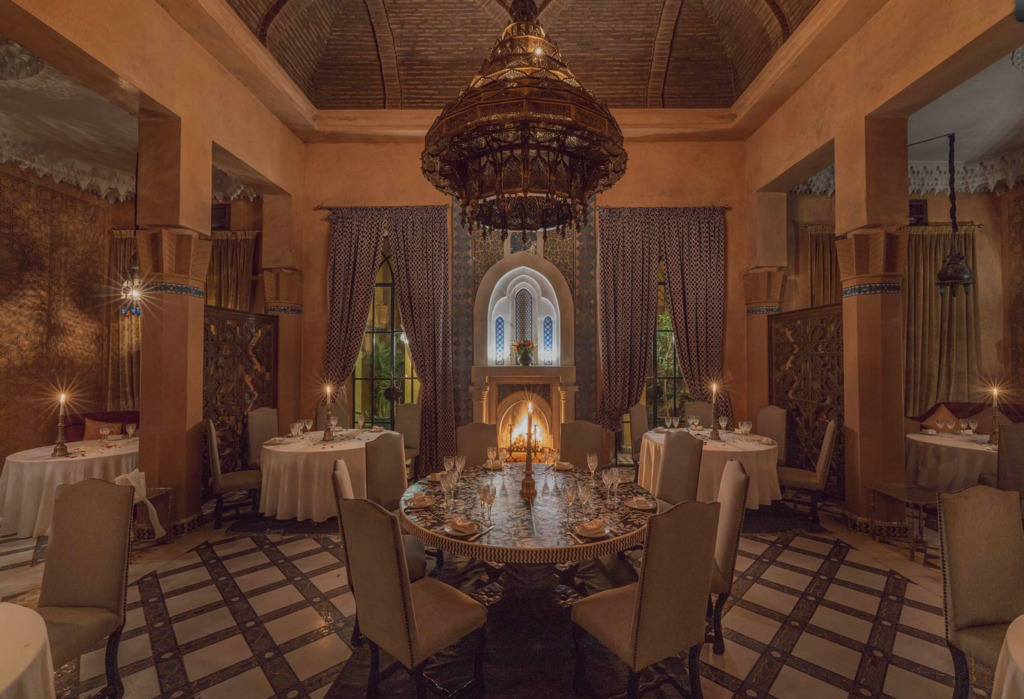 Dar Yacout'un Marakeş'in ikonik restoranları arasındaki yerini vurgulayan bu ihtişamlı yemek salonunda, geleneksel Fas mimarisinin zarif detayları, kemerli pencereleri, mozaik desenli zemini, büyük oymalı avizesi ve şömine ateşiyle aydınlanan romantik masalar, unutulmaz bir deneyim için misafirlerini ağırlıyor.