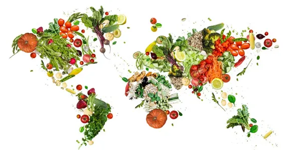 Reducetarian yaşam tarzını simgeleyen sebze ve meyvelerle oluşturulmuş renkli dünya haritası illüstrasyonu.