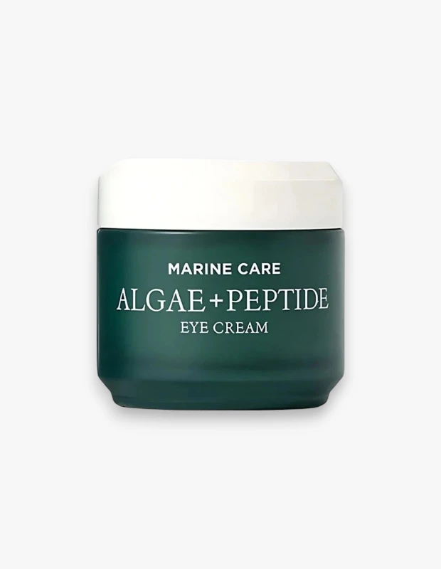 Koyu teal rengi gövdeye ve beyaz kapağa sahip, ön yüzünde Marine Care Algae + Peptide Eye Cream yazan Heimish markalı göz kremi kavanozu, göz çevresi bakımı için özel olarak formüle edilmiş bir ürünü gösteriyor.