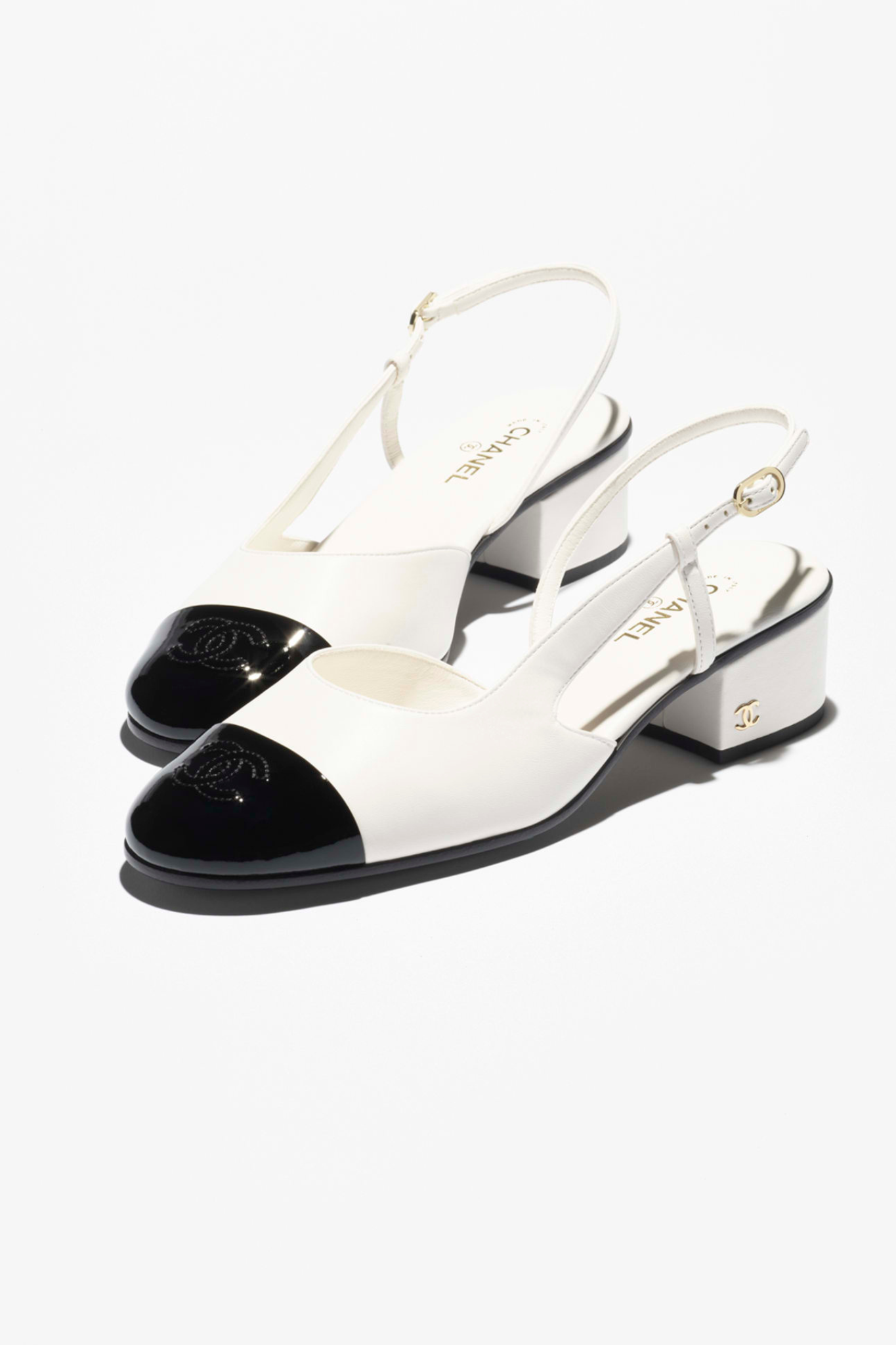 Chanel slingback ayakkabı modeli, beyaz deri gövde ve siyah burun detayıyla ikonik iki renkli tasarım ve zamansız Paris şıklığı.