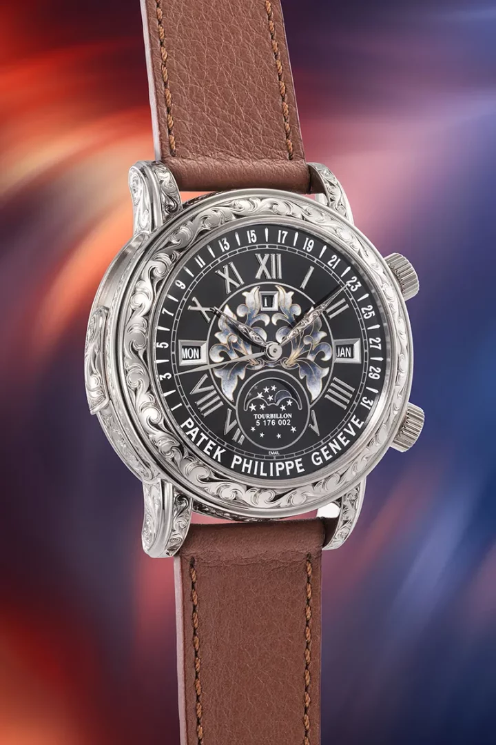 Patek Philippe imzalı, kasanın etrafı el oyması süslemelerle bezeli, siyah kadranında Romen rakamları, ay evresi ve gün/ay göstergeleri bulunan, kahverengi deri kayışlı bu özel lüks kol saati, ince işçiliğiyle dikkat çekiyor.