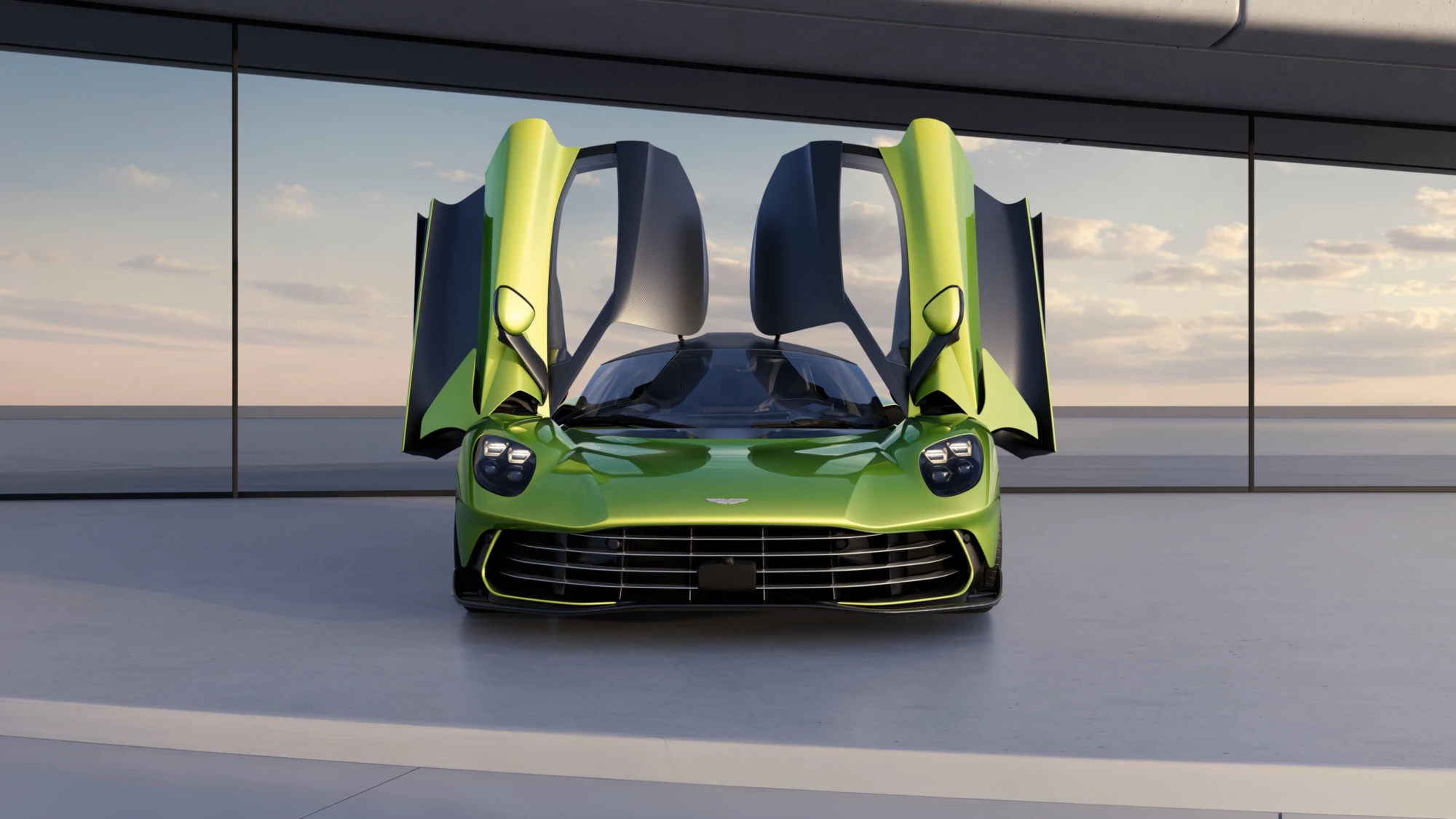 Açık kapılı parlak yeşil Aston Martin Valhalla hypercar, Formula 1 teknolojisiyle geliştirilen çarpıcı tasarımı ve üstün performans özellikleriyle, arkasında bulutlu gökyüzünün yansıdığı cam cepheli modern bir yapının önünde güçlü bir duruş sergiliyor.