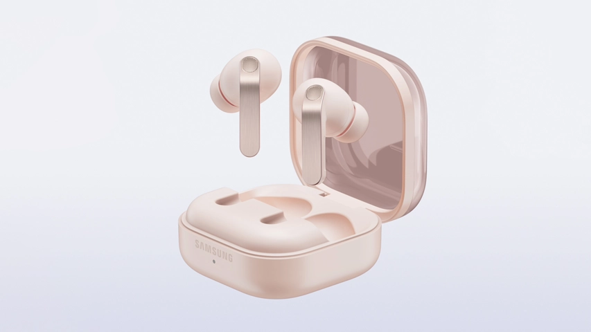 Açık rose gold renkli Samsung Galaxy Buds 4 Pro kulaklıkların şarj kutusu açık haldeyken, bir kulaklık kutunun hemen üzerinde duruyor, diğer kulaklık ise kutunun yuvasında hafifçe yükselmiş olarak konumlanıyor; rose gold tonlarında metalik saplarıyla bu şık kulaklıklar, modern bir görünüm sergiliyor.