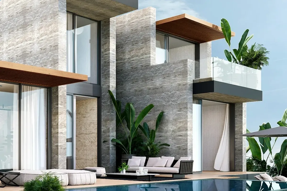 Modern mimariye sahip, gri mermer kaplı, tropikal bitkilerle bezenmiş lüks bir otel veya villa, özel havuzu ve şık dış mekan mobilyalarıyla Türkiye'nin en iyi aile otellerinden birinde huzurlu bir tatil deneyimi vadediyor.