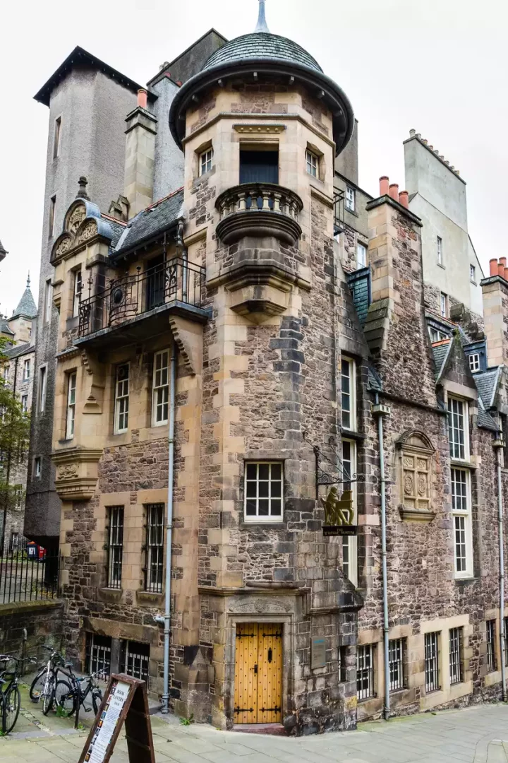 Edinburgh'daki Yazarlar Müzesi'nin ana girişi, köşede yer alan düzensiz kesme taşlardan yapılmış, konik çatılı yuvarlak kuleye sahip tarihi yapının altındaki ahşap kapıdan sağlanırken, cephede de müzenin adını taşıyan demir bir asma tabela göze çarpmaktadır.