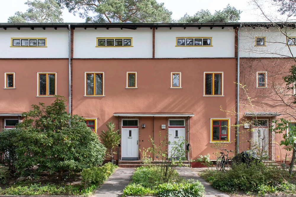 Berlin'de, kırmızımsı kahverengi ve beyaz dış cepheleri, renkli pencere çerçeveleri, düz çatıları ve yeşilliklerle çevrili ön bahçeleriyle öne çıkan bir sıra modernist toplu konut binası, erken 20. yüzyıl konut reformu hareketinin önemli bir örneği olarak UNESCO Dünya Mirası Listesi'ndeki yerini temsil ediyor.