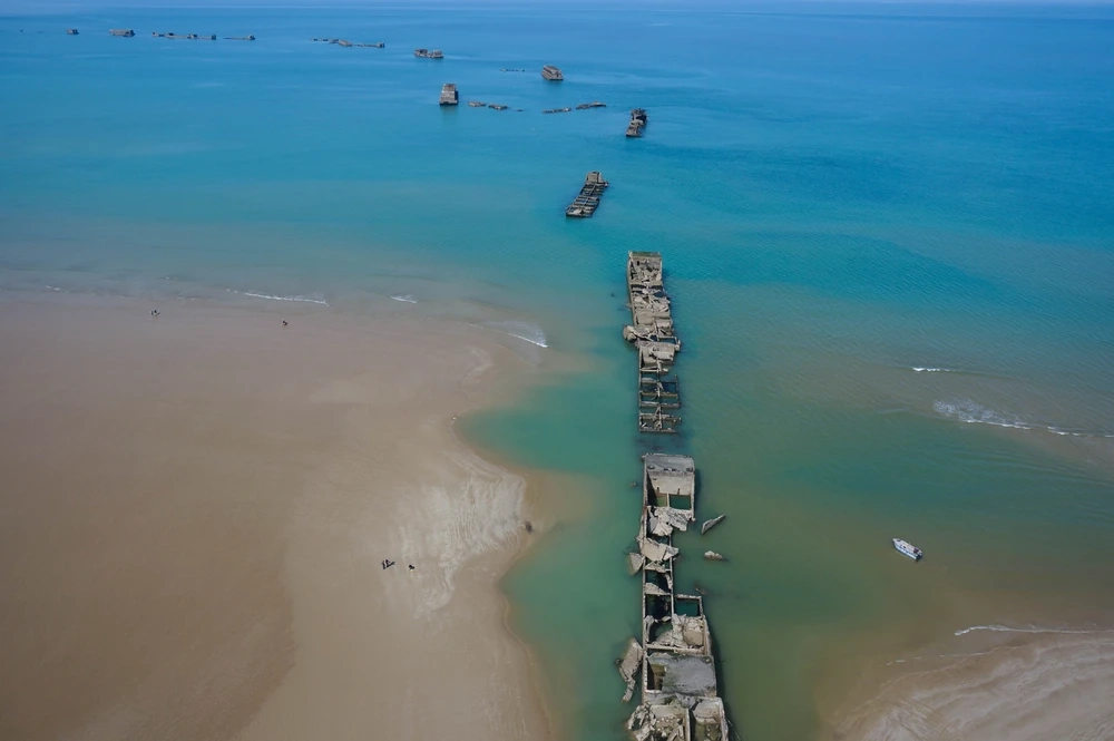 Normandiya Çıkarması D-Day Plajları'nın UNESCO Dünya Mirası Listesi'ne eklenmesiyle, İkinci Dünya Savaşı'nın dönüm noktalarından olan 1944 çıkarmasında kullanılan yapay liman kalıntıları, kumlu kıyı boyunca uzanan masmavi denizde tarihi bir kültürel manzarayı oluşturuyor.