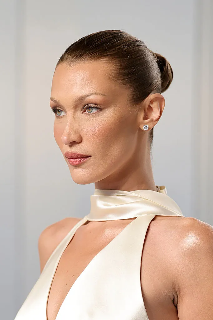 Dünyaca ünlü süpermodel Bella Hadid, belirgin yüz hatları, kusursuz makyajı ve kendine özgü stilini yansıtan modern bir kombinle kameraya odaklanmış, moda dünyasındaki ikonik duruşunu ve trend belirleyici etkisini vurgulayan etkileyici bir portre sunuyor.