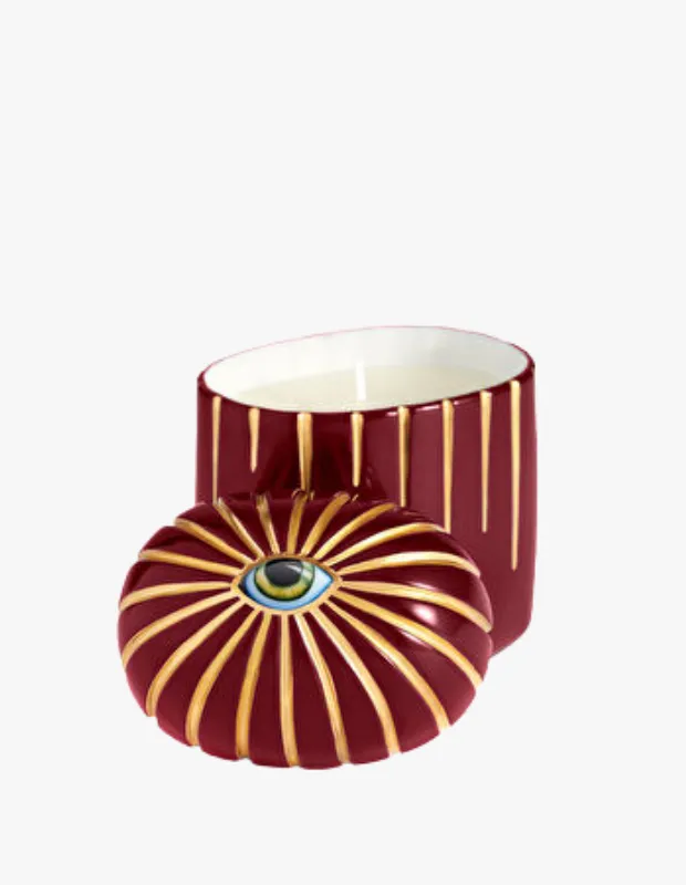 Bordo ve altın detaylı kabı, kapaktaki göz motifiyle dikkat çeken L'Objet Lito dekoratif mum.