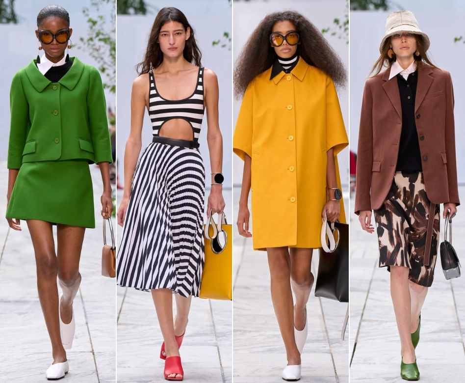 New York Moda Haftası Michael Kors defilesinden, canlı yeşil etek takımından çizgili midi eteğe, sarı oversize palto ve kahverengi blazer ile desenli eteğe kadar birbirinden farklı, şık ve modern dört kadın modelin podyumda yürüdüğü geniş bir görsel.