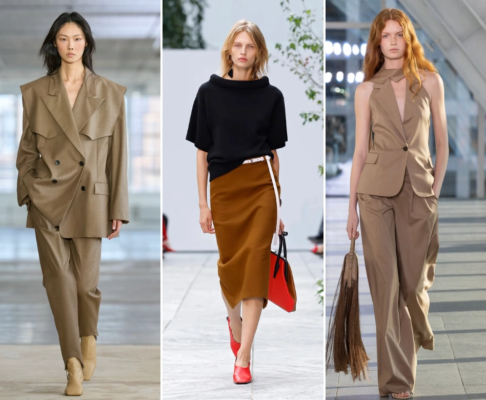 Üç farklı model, New York Moda Haftası podyumunda modern ve şık takımlar sergiliyor: solda geniş yakalı camel rengi bir takım elbise, ortada siyah bluz ve pas rengi etek kombinasyonu, sağda ise kolsuz, şal yaka bej bir pantolon takımı.