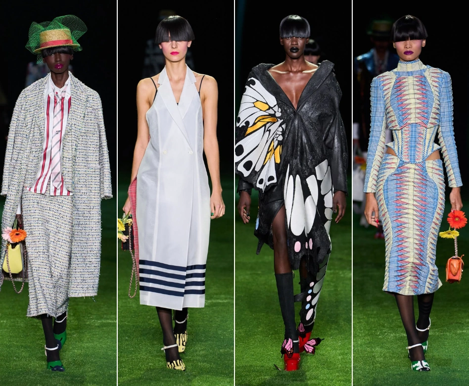 New York Moda Haftası kapsamında Thom Browne'ın defilesinden, yeşil çim kaplı podyumda yürüyen dört model; soldan sağa sırasıyla, tüvit takım, lacivert şeritli beyaz kolsuz elbise, büyük kelebek kanadı detaylı siyah ceket ve karın dekolteli geometrik desenli bir elbise sergiliyor.