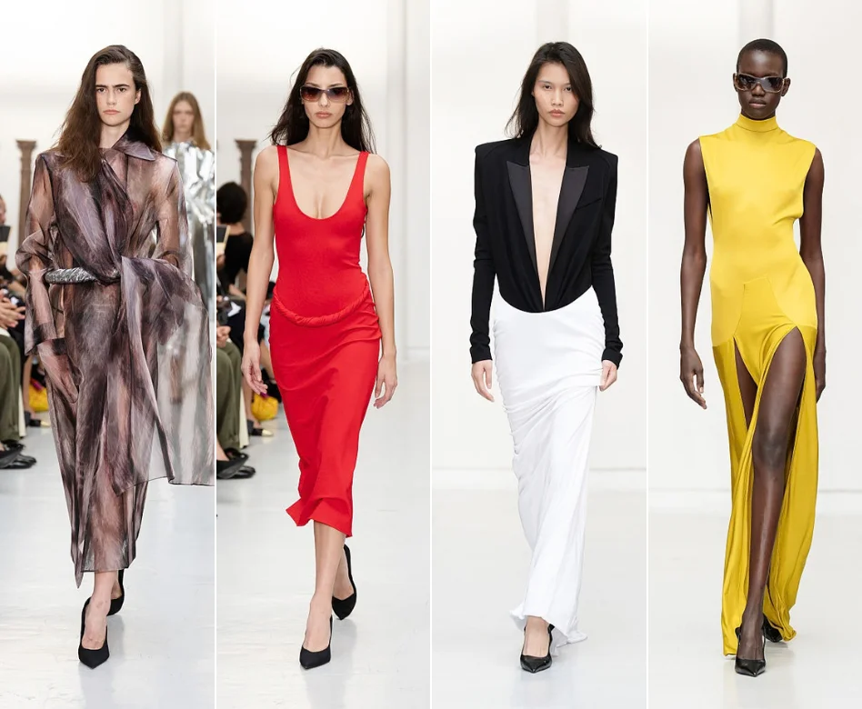 Paris Moda Haftası'nda Burc Akyol koleksiyonundan özel tasarım bir kıyafet sergileyen uzun boylu bir model, keskin çizgili ve sofistike detaylara sahip bir siluetle podyumda kendinden emin bir şekilde yürürken, çevredeki karanlık ortam ve seyirciler flu bir arka plan oluşturuyor.