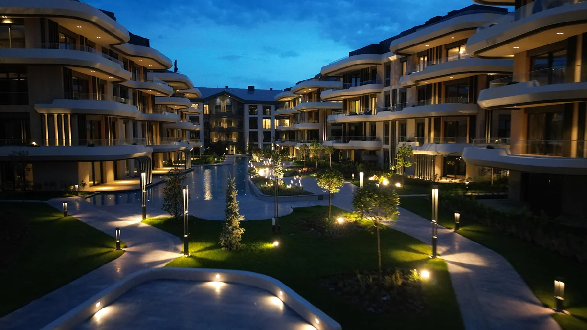 NİVAK Florya’da yeni lüks peyzaj anlayışına eşlik eden, akşam ışıklarıyla aydınlatılmış su ögeleri ve yürüyüş yolları.