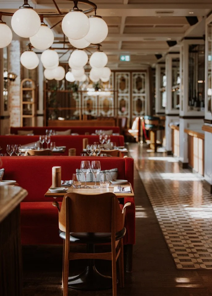 Kopenhag'daki Villa Copenhagen'ın çağdaş ve sofistike tasarımını yansıtan bu ferah lobi veya lounge alanı, yüksek tavanları, doğal ışığı içeri alan geniş pencereleri ve modern sanat eserleriyle zenginleşen zarif mobilyalarıyla dikkat çekiyor.